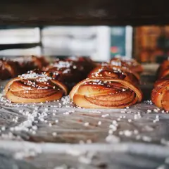 Nybakade kanelbullar, en självklarhet i Sverige, ligger redo att avnjutas. Strösslade med pärlsocker.
