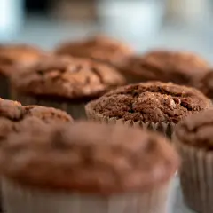 Chokladmuffins i pappersformar. Dessa fluffiga godsaker, som visar vad som innehåller bakpulver, ser aptitliga ut.