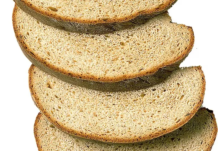 Skivor av mörkt bröd staplade på varandra. Perfekt för ett gott limpa recept.
