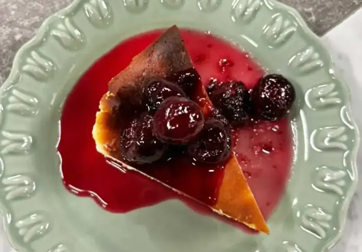 En bit krämig ostkaka med körsbärssås, perfekt för ett ostkaka recept.