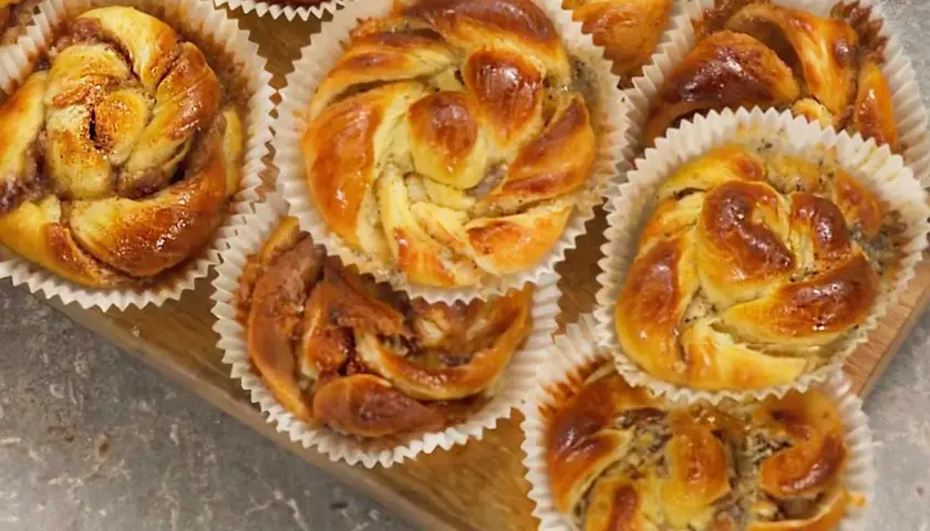 Nybakade bullar med mandelmassa, vackert snurrade och glansiga, redo att avnjutas.