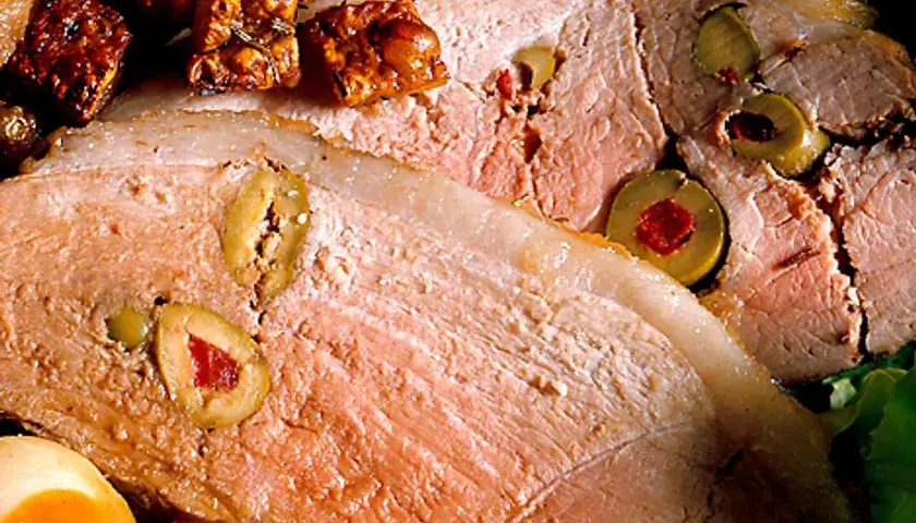 Skinkstek recept: saftig skinkstek fylld med oliver och serverad med potatis och en krispig sallad.