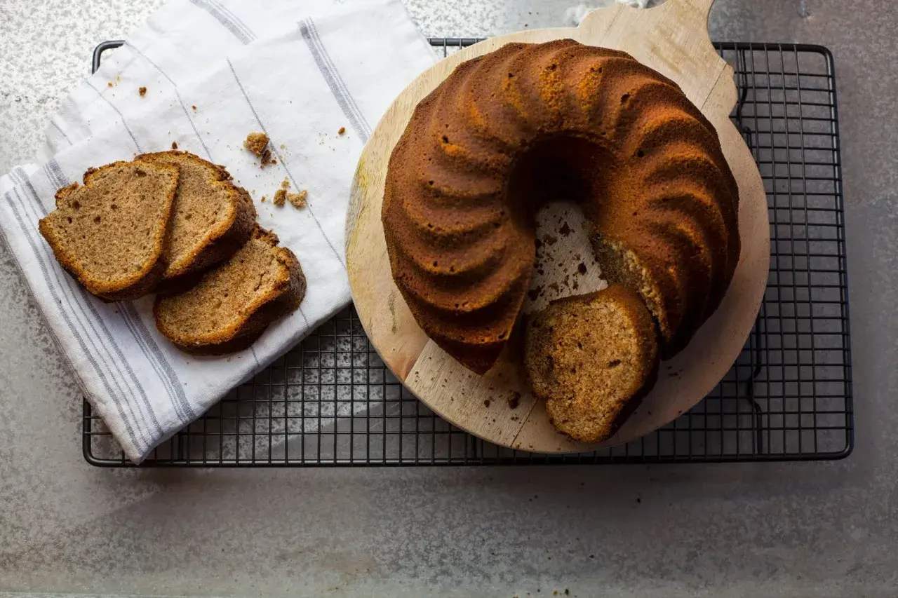 En saftig sockerkaka, likt mjuka pepparkakor i smaken, ligger på ett träfat. Tre skivor ligger bredvid på en vit handduk.